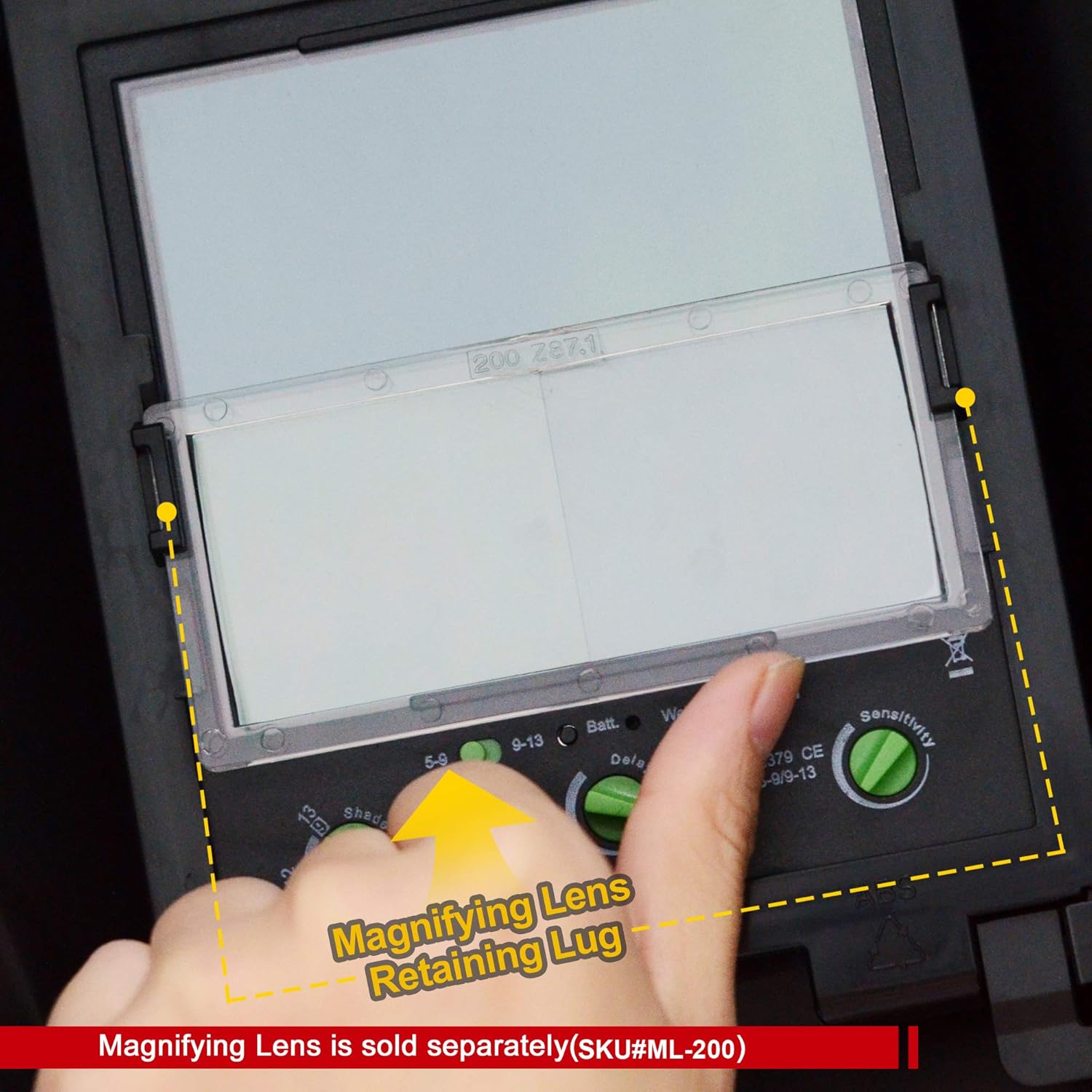 Hand holding a magnifying glass Antra ML-200 over an Antra AH7-860 lens on a black background. 